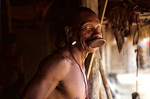 a Kayapo man with traditional lip plate and ear plugs